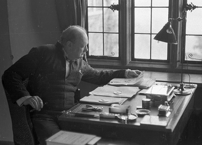 Churchill in his siren-suit at his desk in his country home Chartwell in 1939.